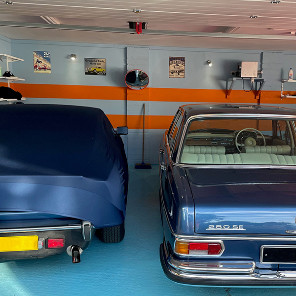 Image of two classic cars being stored in a dehumidified garagee.