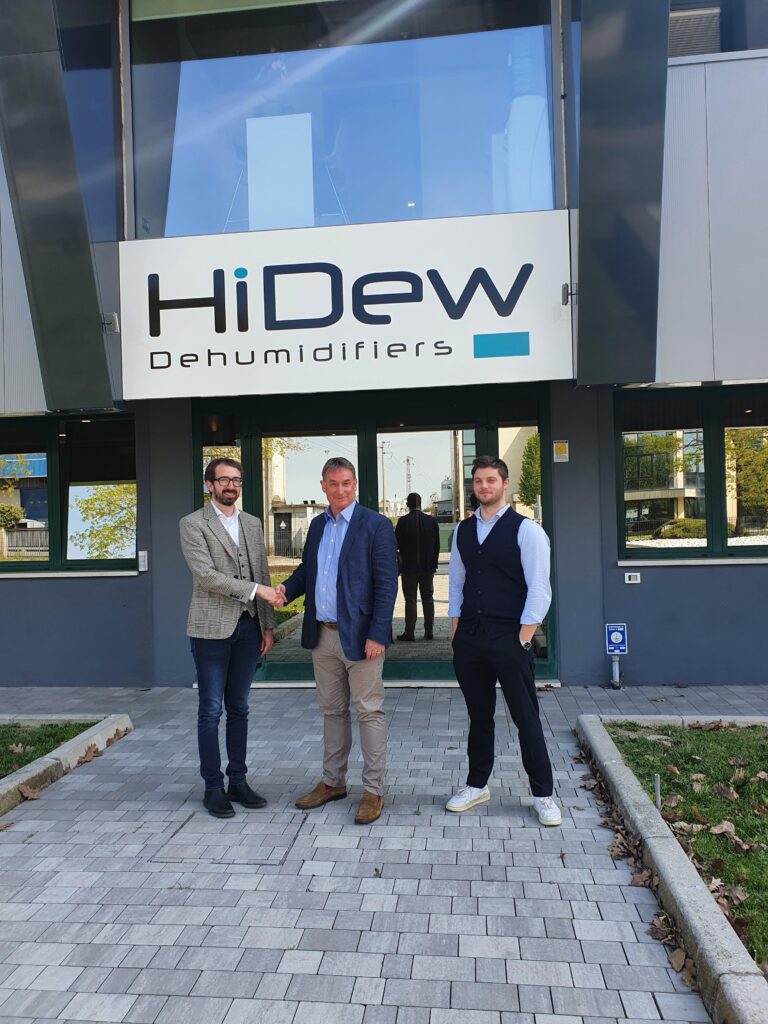 John Barker shaking hands with HiDew Staff